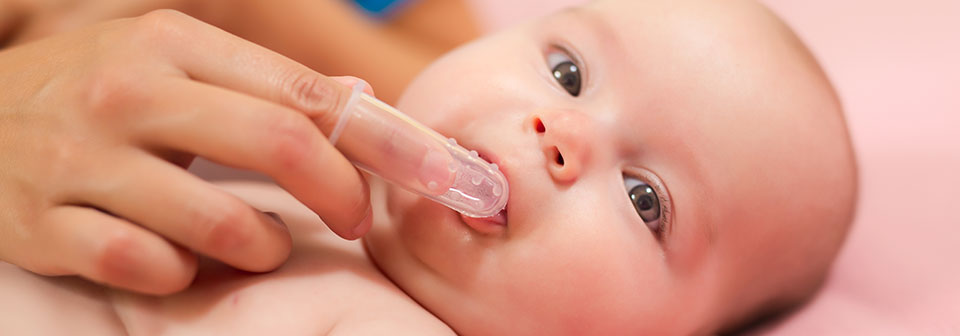 ребенок с насадкой для чистки детских зубов